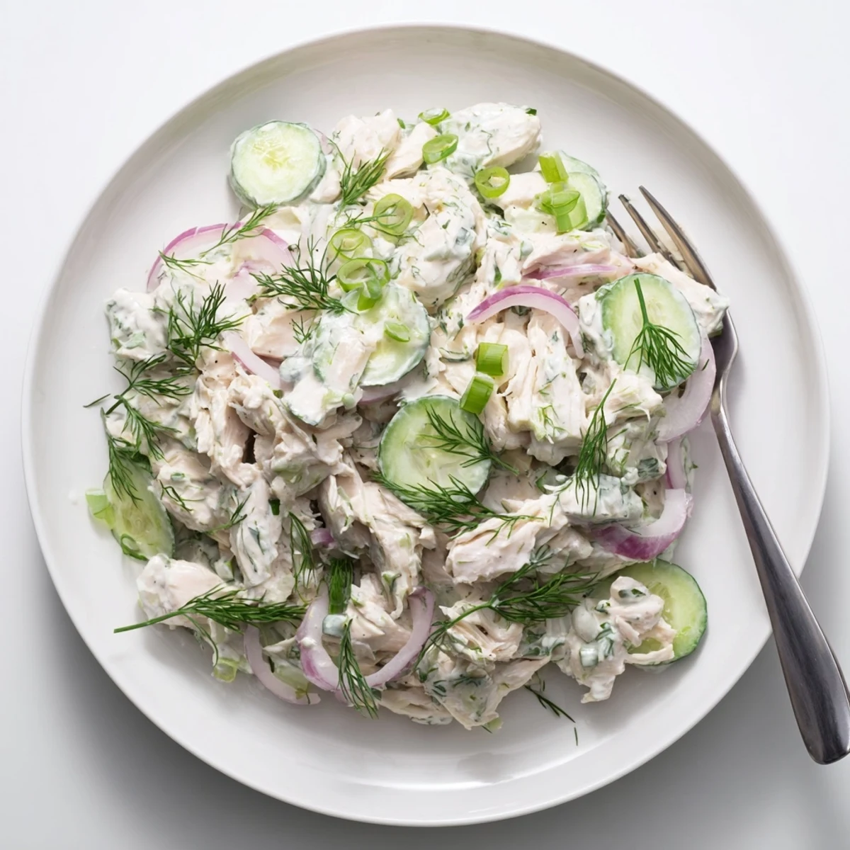 Tender shredded chicken and cool cucumbers tossed in tangy Greek yogurt dressing for this high-protein Creamy Cucumber Chicken Salad.
