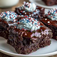 Fudgy brownie bites with creamy frosting and red, white, and blue sprinkles for a festive Independence Day dessert.  